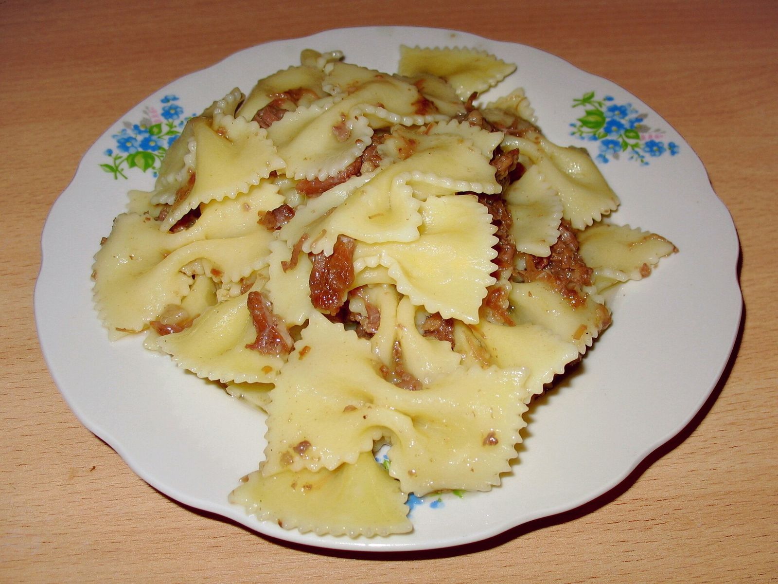 Макароны-бабочки с фаршем на тарелке